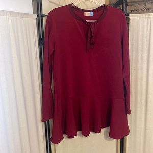 Altar’d State long sleeve textured fabric tunic top with flared detail at waist.